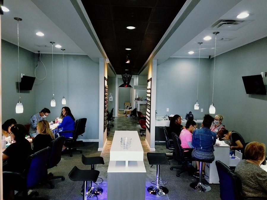 Busy main floor of Queen Nail Spa Southside with manicure stations