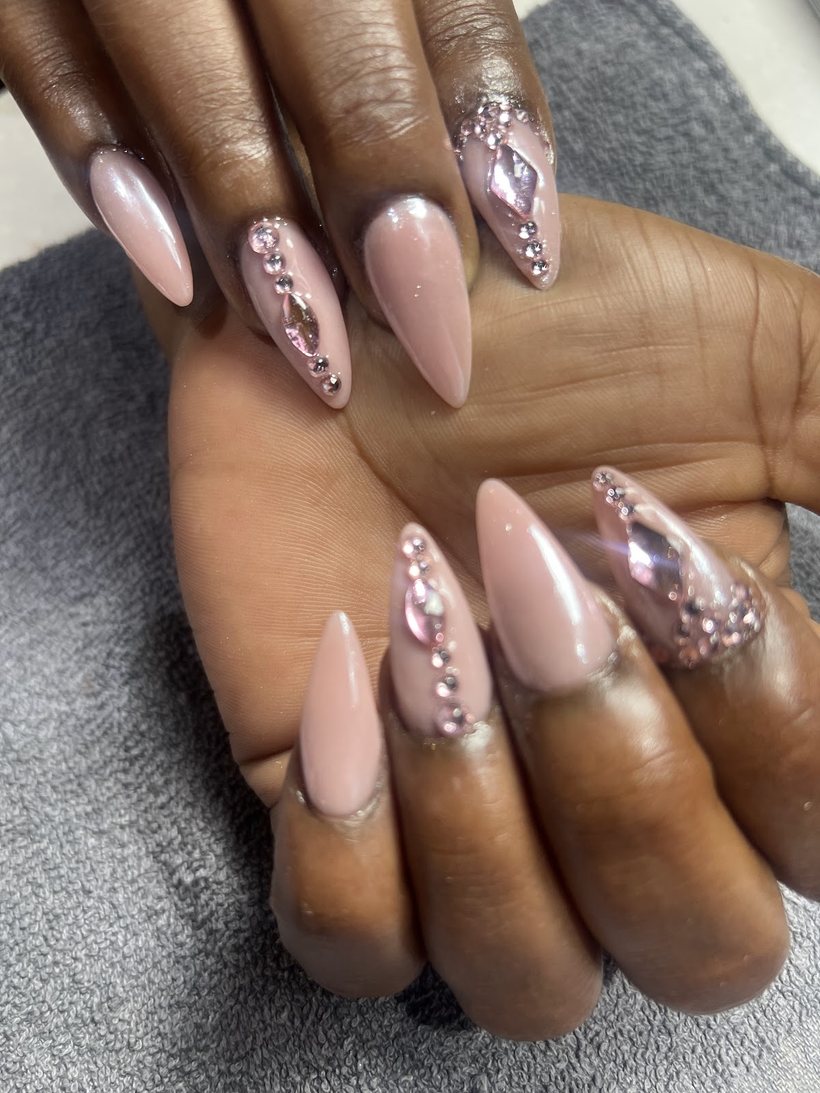 Pink chrome stiletto nails with crystal gem accents by Queen Nail Spa Southside